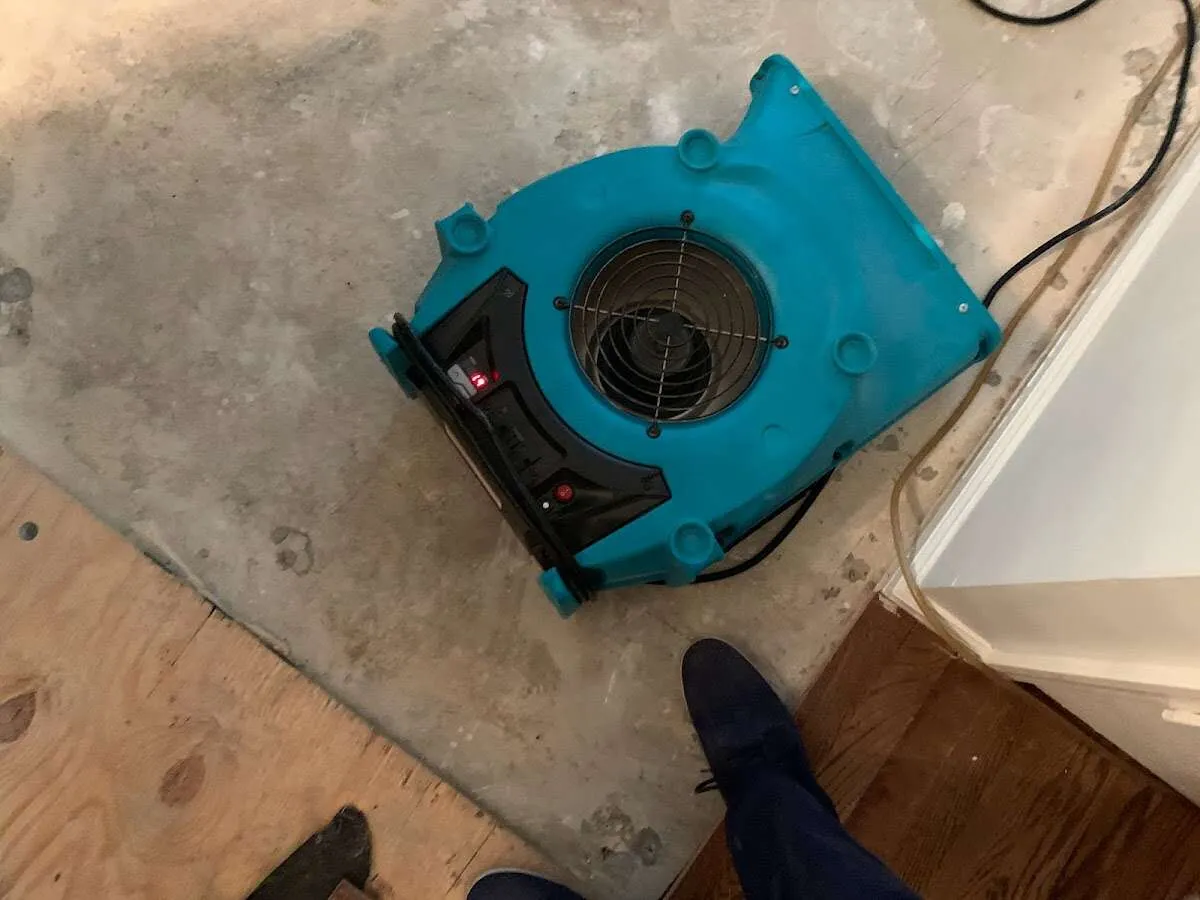 Air mover drying subfloor during Commercial Water Damage Restoration in Jasper